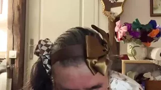 In an outfit with a little brown skirt to suck a dildo