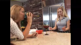 Two blondes explore each other's bodies in the kitchen