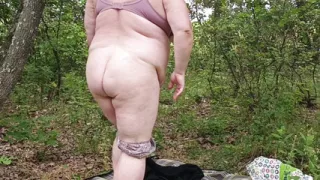 Mother-in-law undressed in a public park and masturbates her pussy