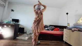 Sexy mom has fun trying on clothes and cutting them.