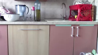 Sexy wife having fun in the kitchen with roses. Sexy naked wife preparing food in the kitchen.