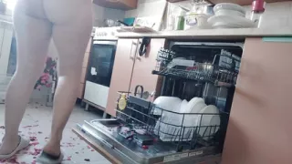 Sexy naked woman preparing food in the kitchen. Hairy brown hair, big ass, big.