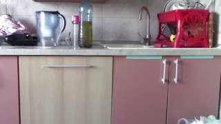 Sexy naked woman preparing food in the kitchen. Hairy brown hair, big ass, big.