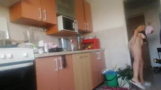 Sexy naked woman preparing food in the kitchen. Hairy brown hair, big ass, big.