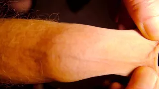 Very Close up on the tip of his uncut penis as he plays with his foreskin and show bell-end