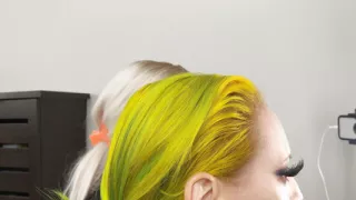 Crossdresser and Woman Putting on Lipliner and Lipstick