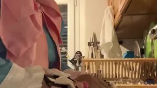 In a blue maid's outfit with pink bows to do the dishes.