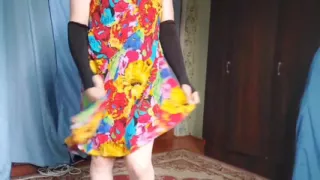 Sweet femboy leaning on balcony railing at sunset