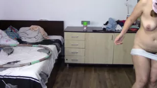 Sexy woman trains naked at home. Sexy brunette tries on pantyhose, hairy pussy, big ass, big tits.