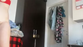 Amateur woman has fun trying on clothes and cutting them.