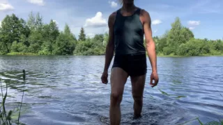 Trans girl Alexa Cosmic swimming and playing in the lake wearing black short and blue top