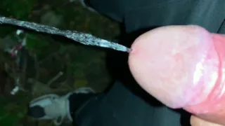 Slowmotion and Close up. Unwashed Uncut Cock Piss on the Ground Outdoor. Long Piss Stream