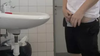 Guy Taking a Urine Sample in Hospital Toilets