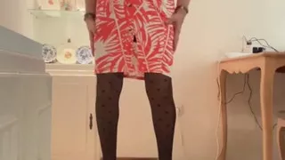 Beautiful and horny Spanish trans girl with long legs cums in an orange dress, skirt and top, black heels, and lingerie