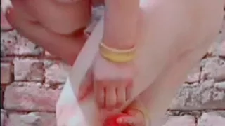 While bathing, the village woman is taking a bath naked after taking off her clothes completely