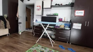 Sexy brunette doing naked chores around the house.