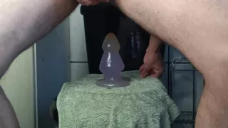 Cumming with giant plug in the ass