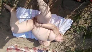 Squirting from masturbation on a common beach