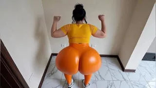 big-bootied woman in orange leggings moving