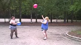 BBW gals play volley ball with balloons