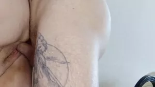 A girlfriend with a big ass stands doggy style and takes a dick in her pussy