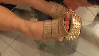 Mistress lets her slave lick her golden shoes