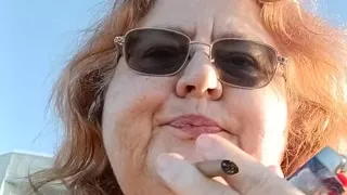 Bearded Lady try's to  lights  on windy beach!