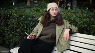 Young Brunette Is Taking an Unhurried Stroll with Allwhite 120mm Cigarette