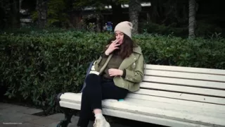Young Brunette Is Taking an Unhurried Stroll with Allwhite 120mm Cigarette