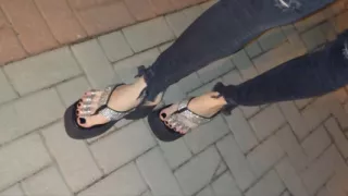 I wear platform flip-flops and tight jeans, showing off my feet.