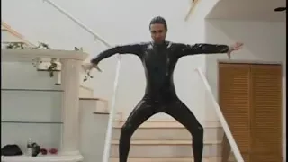Two guys wearing masks get their large cocks sucked by a hot chick in latex gear