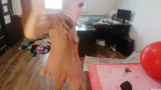 Amateur woman has fun trying on clothes and cutting them.