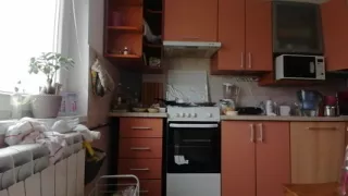 A Sexy Naked Woman Prepares Food in the Kitchen