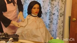 Emma the barberette shows off sexy vinyl shampoo capes