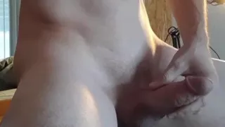 Caressing the erect penis ejaculating.