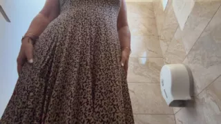 A horny mature MILF is very aroused and is rubbing her pussy in the public restroom at the office.