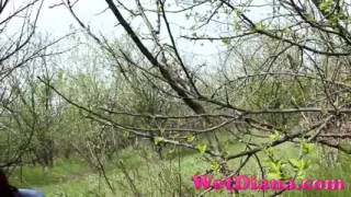 Pissing in the grass with legs wide opened and wipe her pussy with a leaf