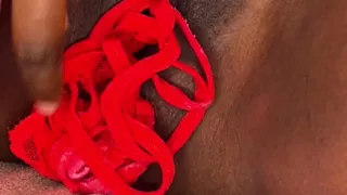 Kinky black Latina stuffing red panties in her pussy
