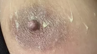 Hot sexy blonde fills her huge nipple with cream