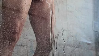 pissing behind the shower glass with uncut dick