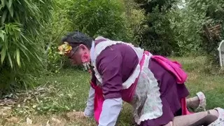 In gardener's outfit, peeing on all fours like a dog