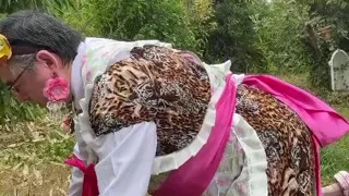 In gardener's outfit with a little leopard dress to pee on all fours