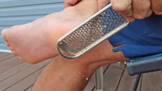 Giving my rough male feet a pedicure and showing my white painted toes