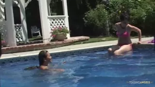 Bored sunbathing lesbian friends are messing with their privates in the outdoor pool