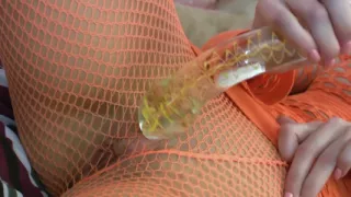 Glass Dildo Solo in an Orange Fishnet Bodysuit - Busty Brunette Plays on the Couch