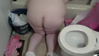 Naked pregnant mom cleaning the bathroom and toilet