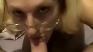 Blond lady in glasses gives a blow job and takes cum