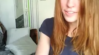 Hot young brunette in a miniskirt raises her shirt in a web