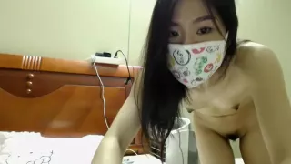 Nubile young brunette in a mask strips on webcam to show of