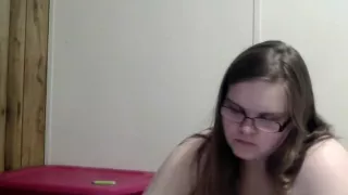 Nerdy girl smokes naked while reading in bed
